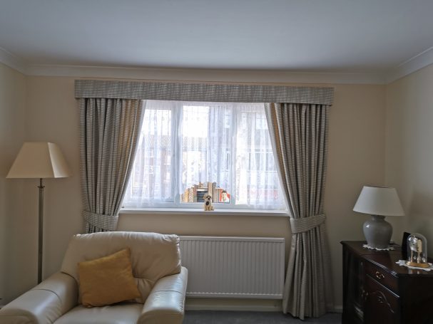 padded box pelmet with pencil pleat curtains and tie backs